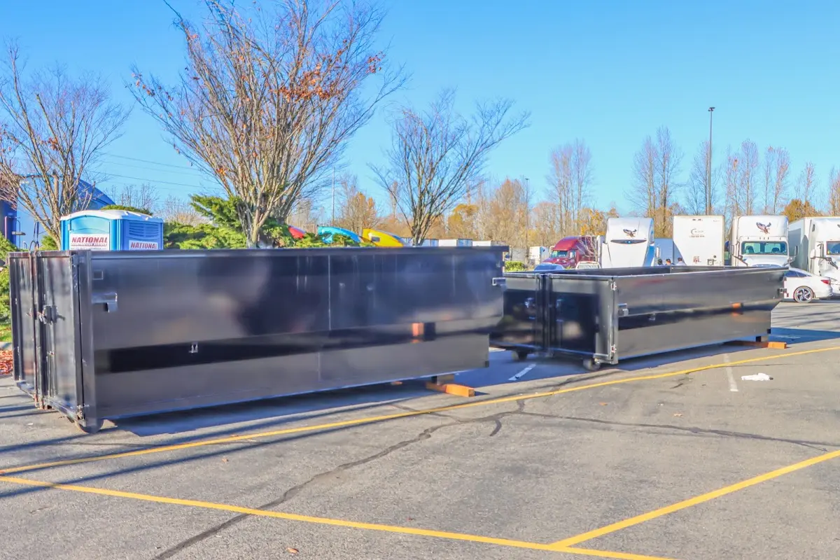 Professional dumpster rental service with roll-off container on residential driveway in Swansea